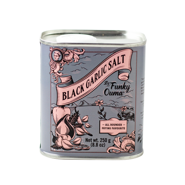 Can of black garlic salt with decorative label on a white background