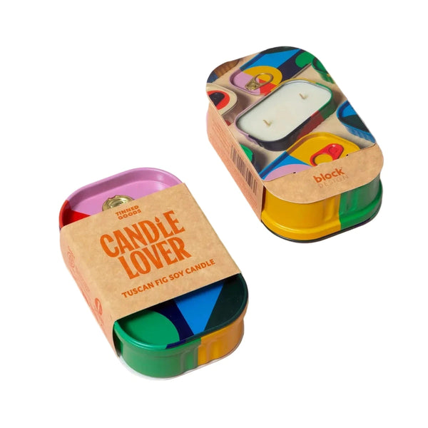 Candle with colorful packaging on a pink background