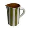 Ceramic pitcher with green and white stripes on a gray background