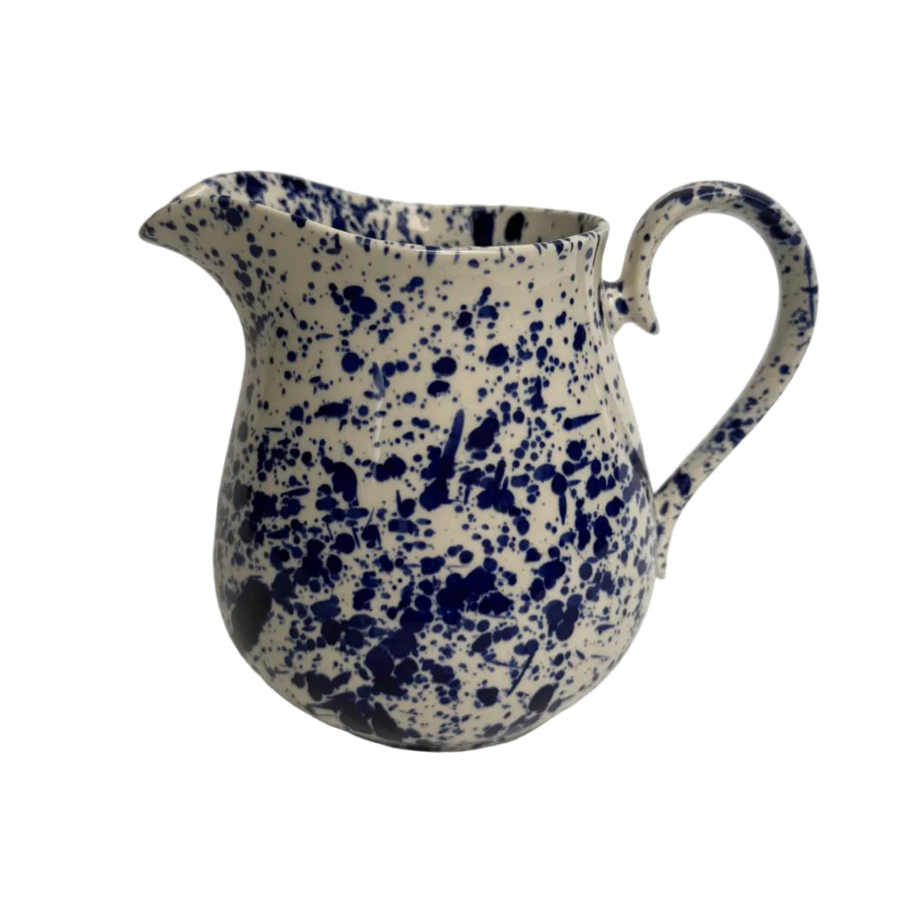 Ceramic pitcher with blue speckled pattern on a white background