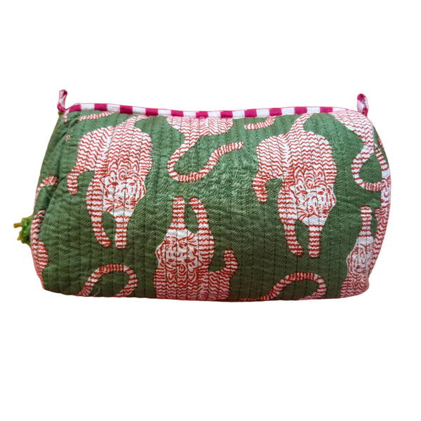Green floral-patterned pouch on an orange background