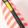Roka Close-up of a striped bag with a yellow zipper on a white background