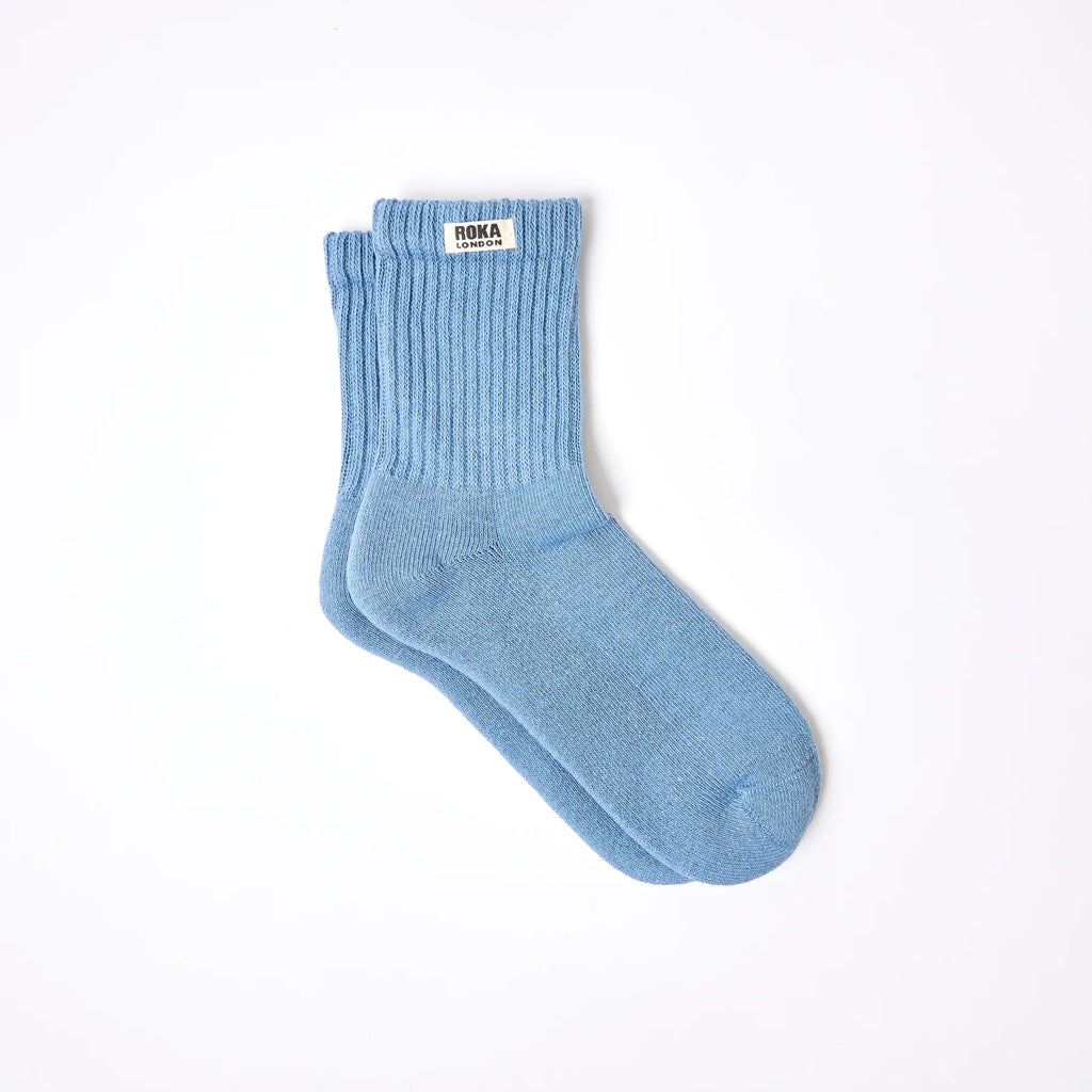Roka Blue sock with a brand label on a white background