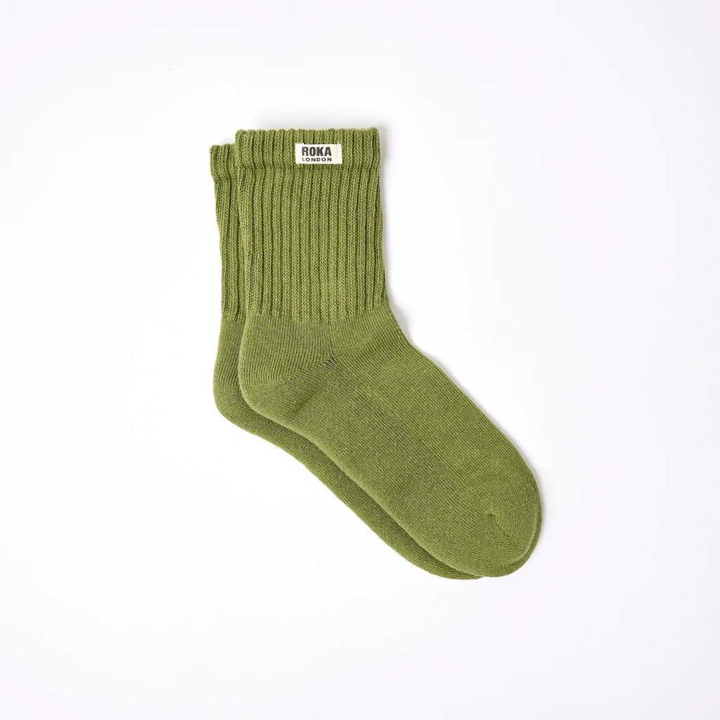Roka Green sock with a brand label on a white background
