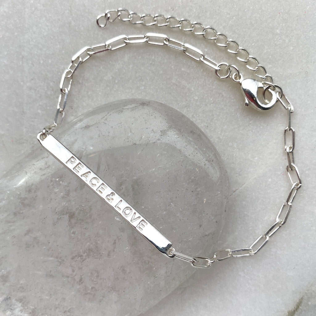 Peace and love sterling silver bar bracelet with cable chain.