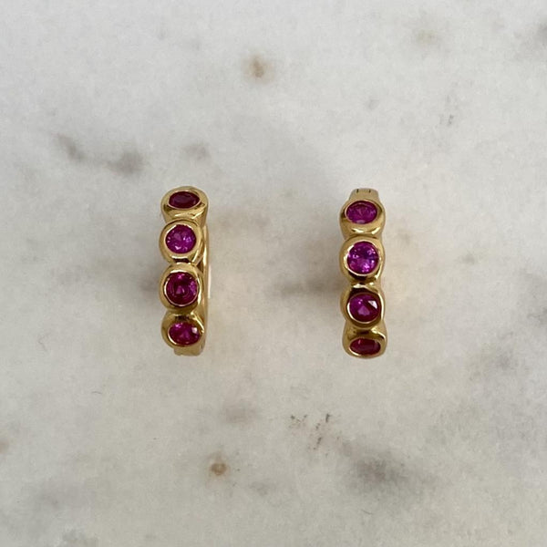 Scream Pretty bezel gold huggie earrings with ruby pink cubic zirconia stones.jpg